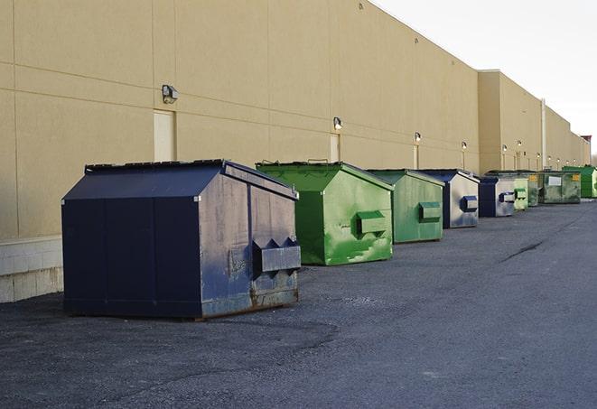 a crowd of dumpsters of all colors and sizes at a construction site in Ashland